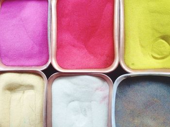 Directly above shot of colored powders at market