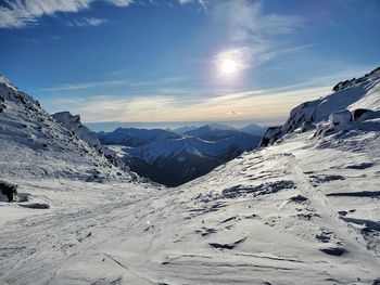 Scenic view of snow covered mountains against sky