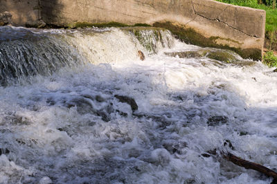 Scenic view of waterfall in sea