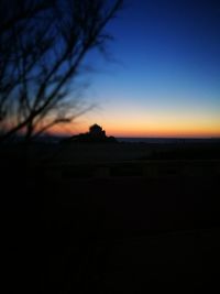 Scenic view of silhouette landscape against sky at sunset
