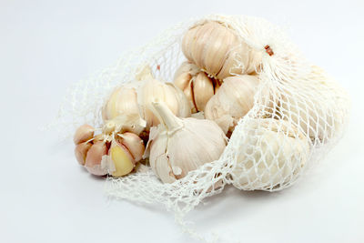 Close-up of garlic on white background
