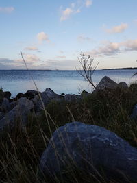 Scenic view of sea against cloudy sky