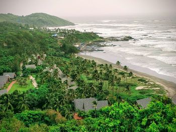 High angle view of trees and sea against sky