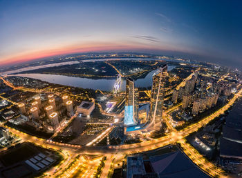 High angle view of illuminated city buildings at night