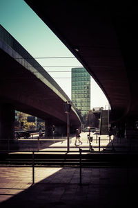 People walking on railroad station platform against sky