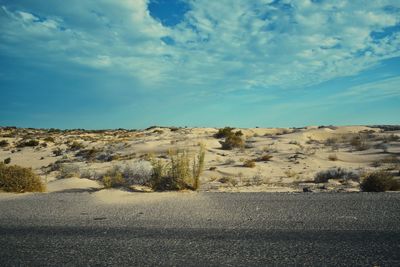 Scenic view of road by land against sky