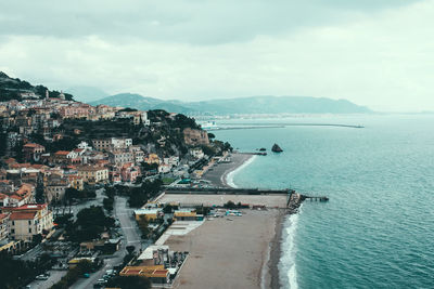 High angle view of sea and buildings against sky