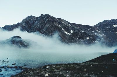 Scenic view of mountains against cloudy sky