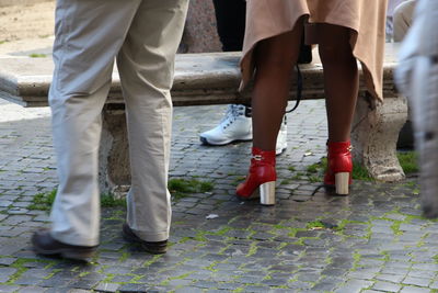 Low section of people standing on footpath