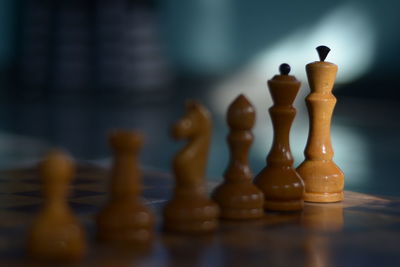 Close-up of chess pieces arranged on board