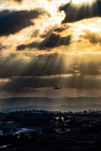 Scenic view of city against sky during sunset