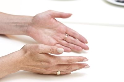 Close-up of human hands on table