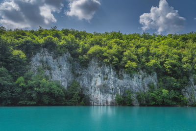 Scenic view of waterfall against sky