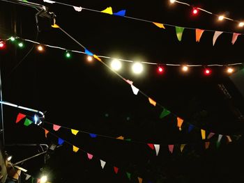 Low angle view of illuminated lights at night
