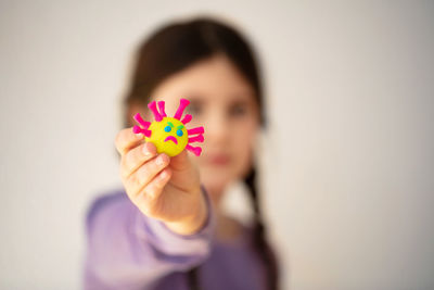 Portrait of woman holding pink flower