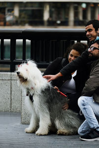 Portrait of man playing with dog