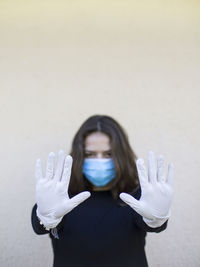 Portrait of woman with hands on white background