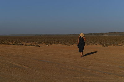 Woman on field against clear sky