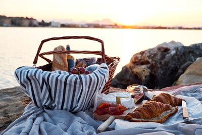 Close-up of food in basket by lake