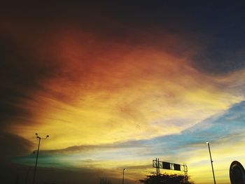 Low angle view of silhouette street against sky during sunset