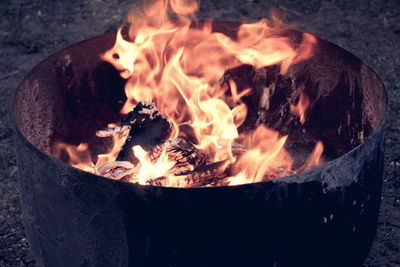 Close-up of fire pit on field at night