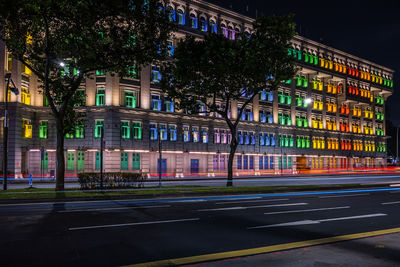 Illuminated city street at night