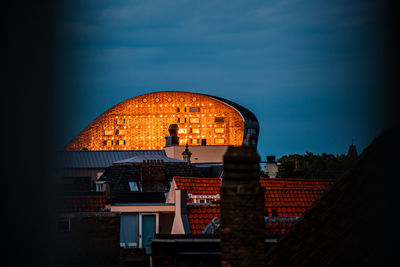 Buildings in city against sky at dusk