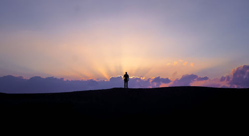 Scenic view of silhouette mountains against sky during sunset