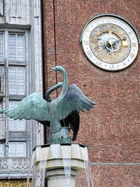 Statue of a bird against building