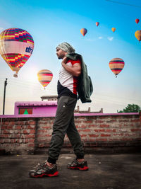 Low angle view of hot air balloons flying against sky