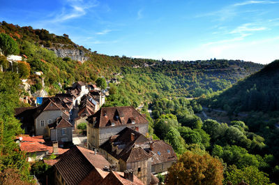 High angle view of houses and trees against sky