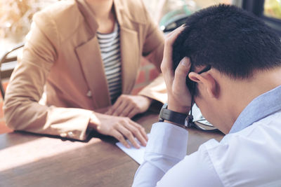 Midsection of business colleagues working at office