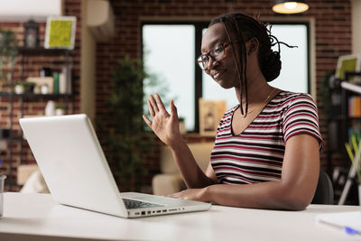 Young woman using laptop on table