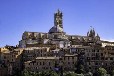 Panoramic view of siena with tiled rooftops, duomo and torre del mangia - tuscany, italy