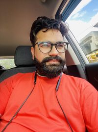 Portrait of man sitting in car