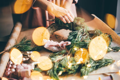 Girl making a handmade christmas wreath. idea for the festive decoration of the interior. 