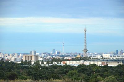 View of cityscape against cloudy sky