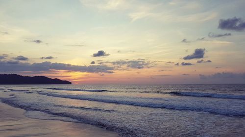 Scenic view of sea against cloudy sky