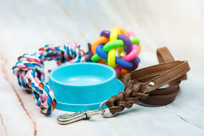 Pet supplies concept. pet leather leashes, brush and rubber toy.