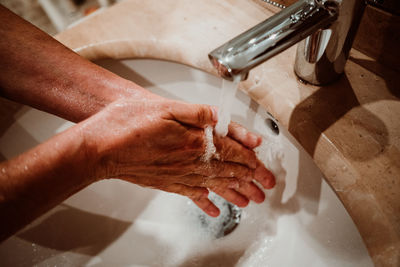 High angle view of hands in bathroom