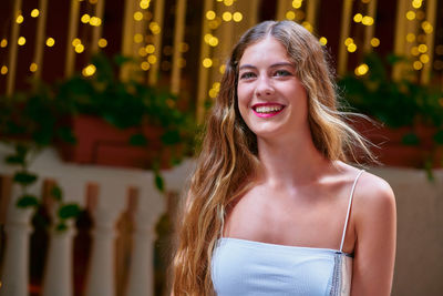 Portrait of smiling woman standing outdoors