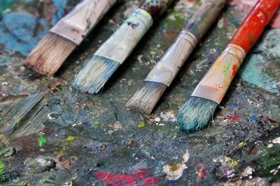 Close-up of paintbrushes on dirty table