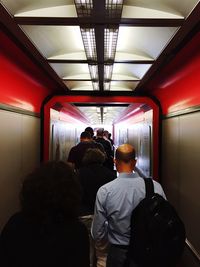 Rear view of people sitting in train