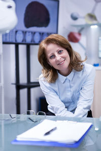 Portrait of businesswoman working at table