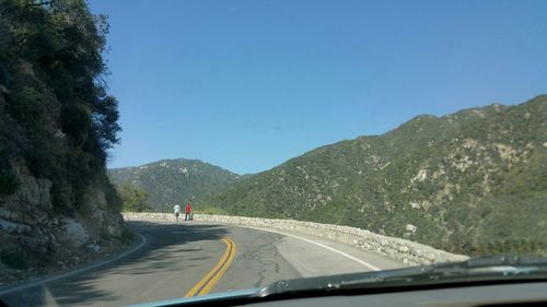 Country road leading towards mountains