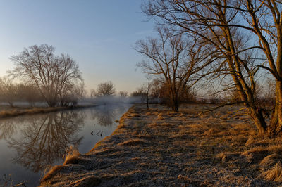 Scenic view of lake against sky during winter