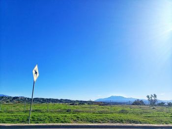 Scenic view of field against clear blue sky