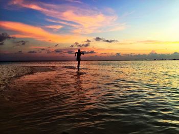 Rear view of man standing on beach