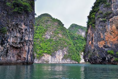 Rock formations by sea against sky