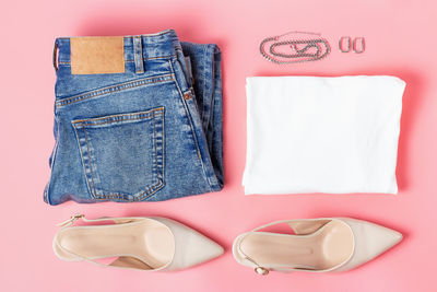 Modern female clothing, flat lay on a pink background top view.
